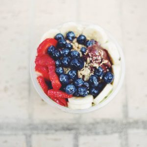 Acai berry bowl topped with strawberries, blueberries, bananas and granola