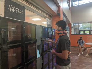 Student using temperature-controlled food locker system at Foy